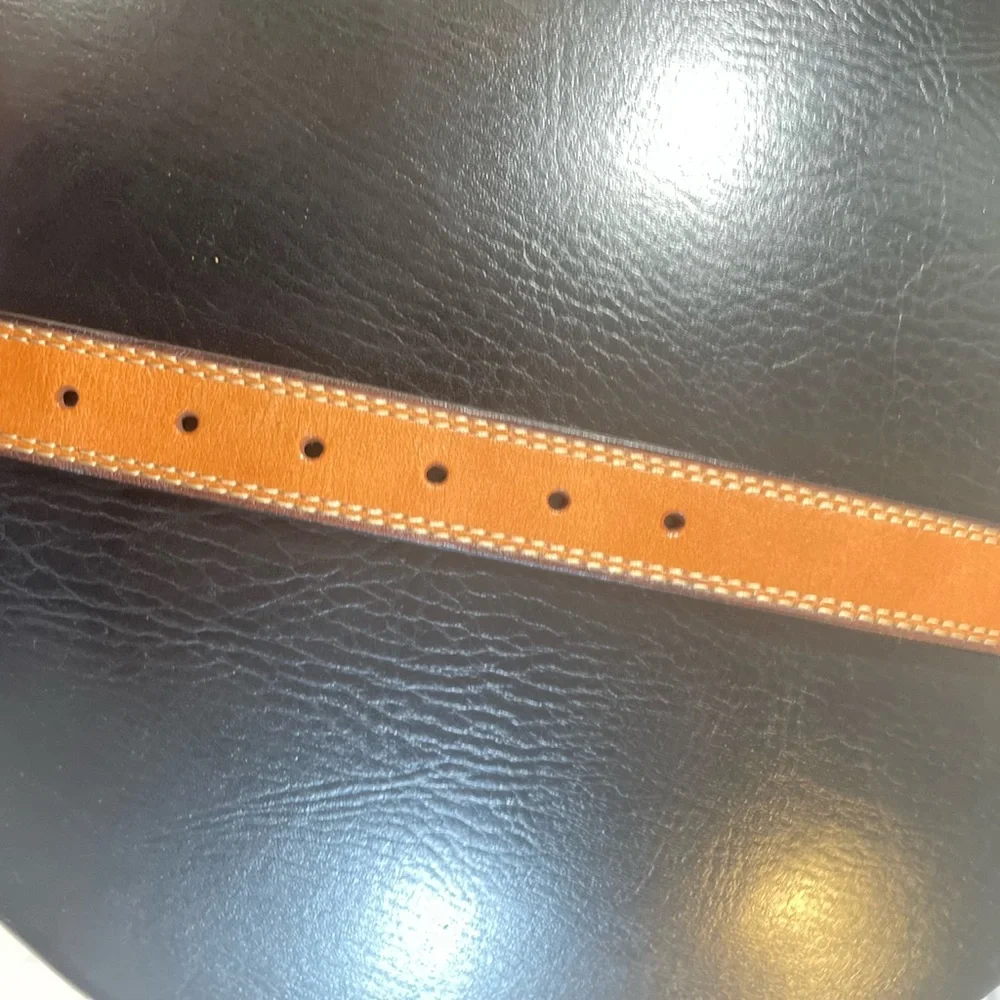 NWOT Genuine leather belt. 31” of leather end to end not including buckle.26/28